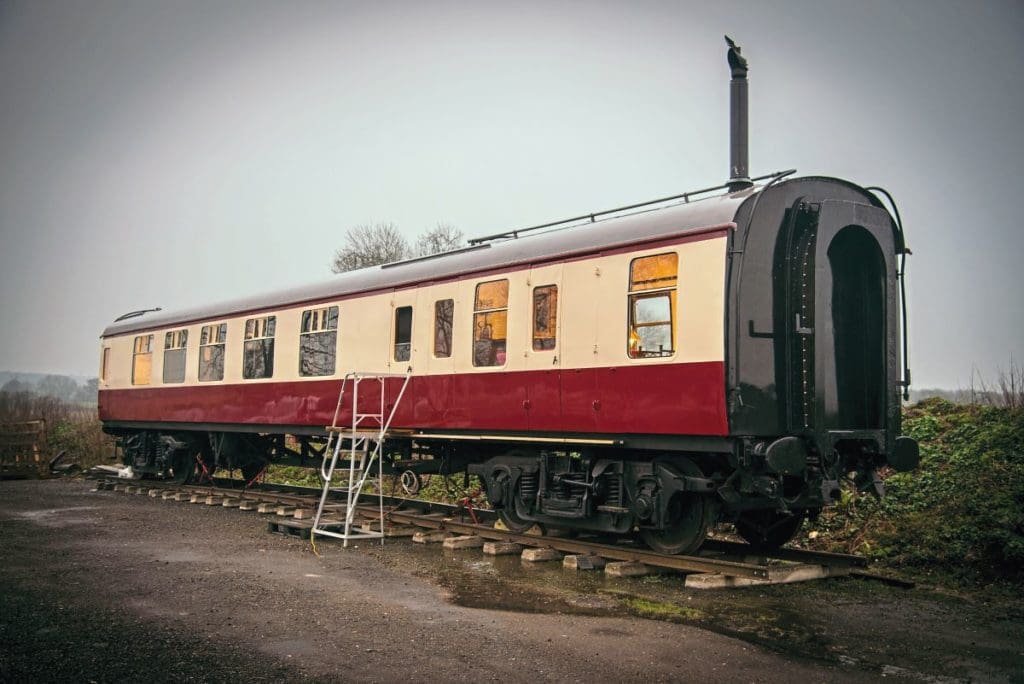 The outside of the coach in carmine and cream colours.